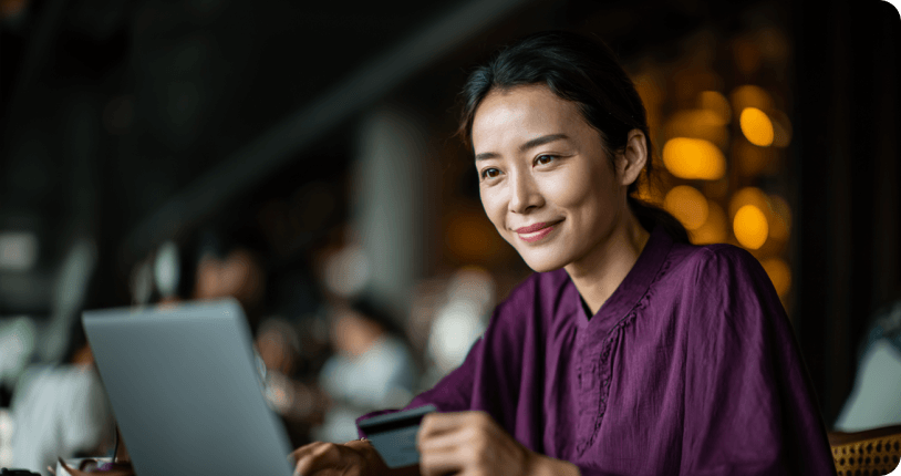 Confident woman managing online transactions on her laptop