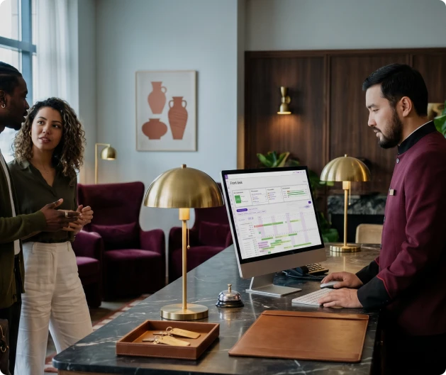 Hotel receptionist working with Exely PMS at the front desk
