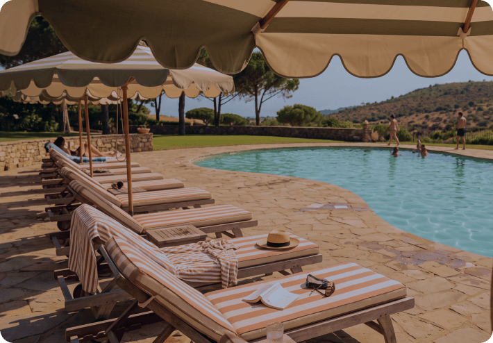 Hotel swimming pool and sun loungers